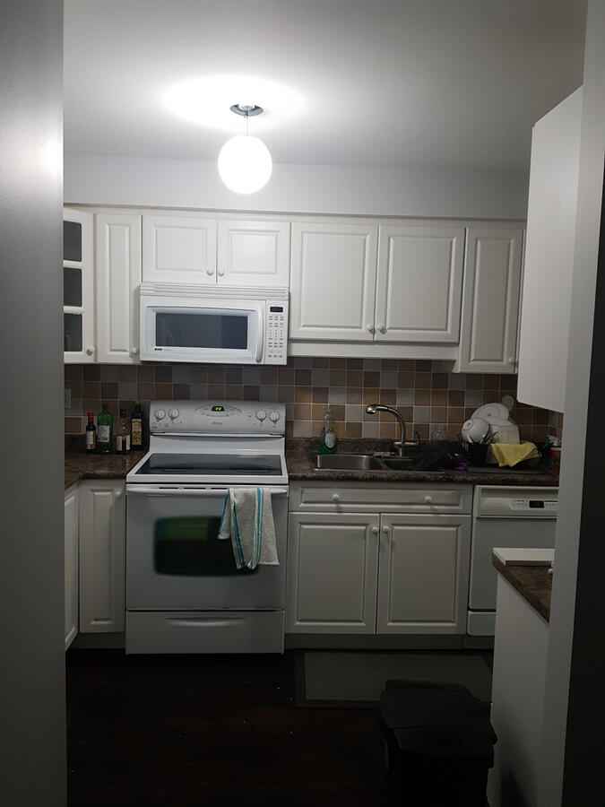 Before: Original Builder Kitchen - Markham ON. Existing kitchen layout prior to renovation with older cabinetry and finishes.