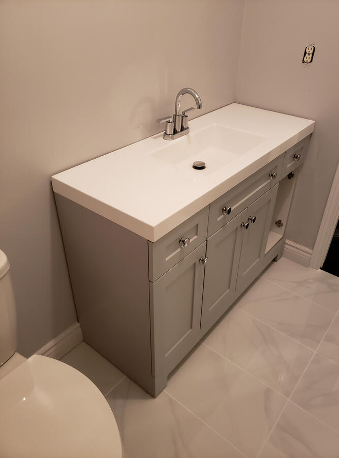 After: Custom Vanity Installation - Aurora ON. New modern vanity with updated sink, fixtures, and large-format tile flooring.